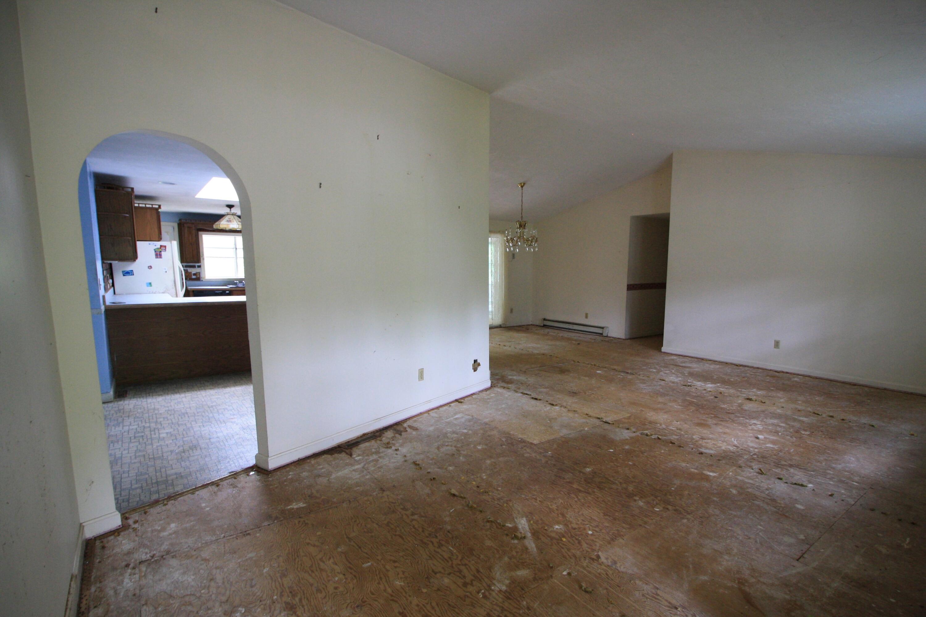 177 Thistle Drive Centerville, MA 02632 - Photo 7 of 22 an empty room with a fireplace and cabinet