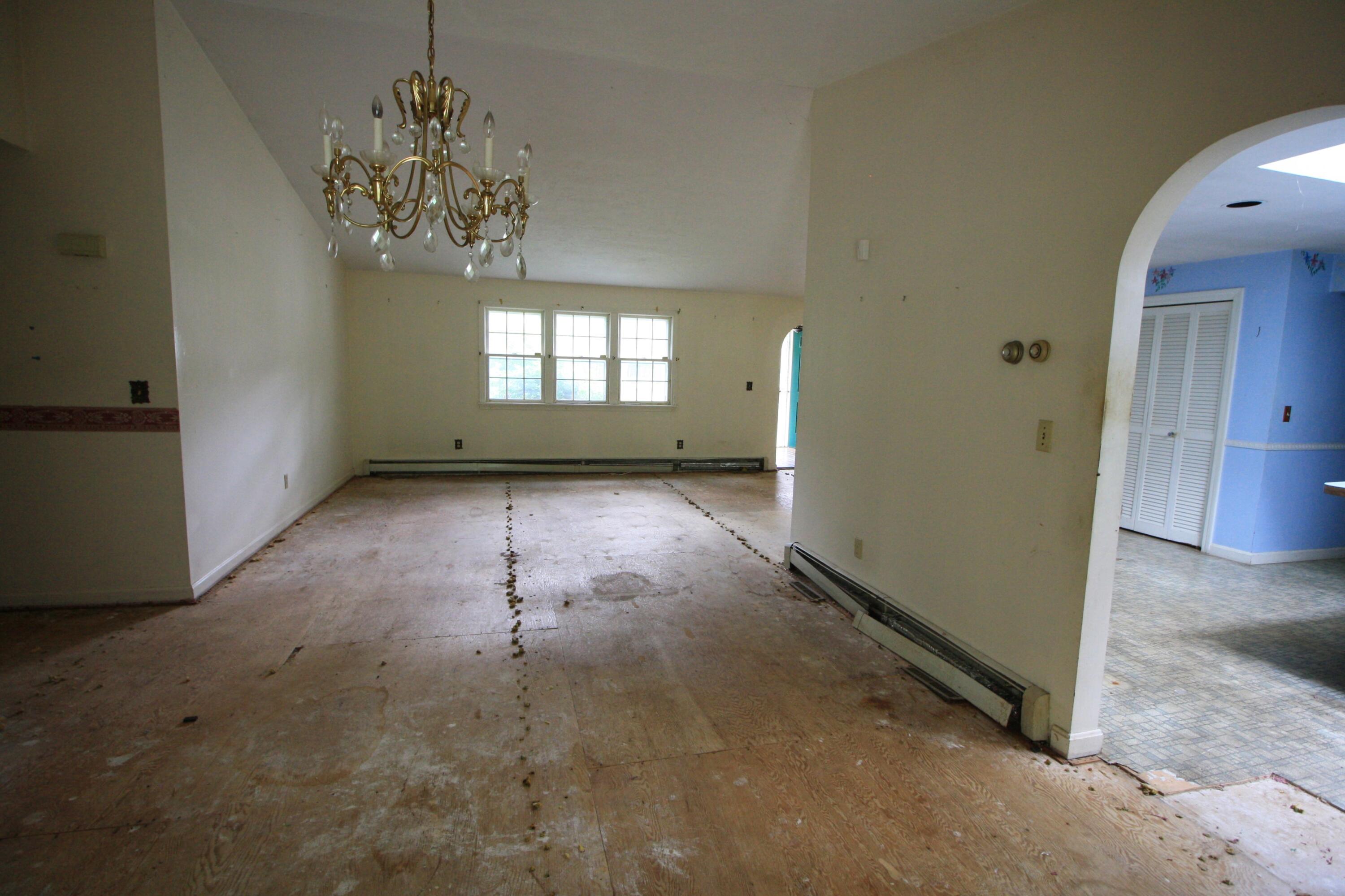 177 Thistle Drive Centerville, MA 02632 - Photo 9 of 22 an empty room with windows and entrance