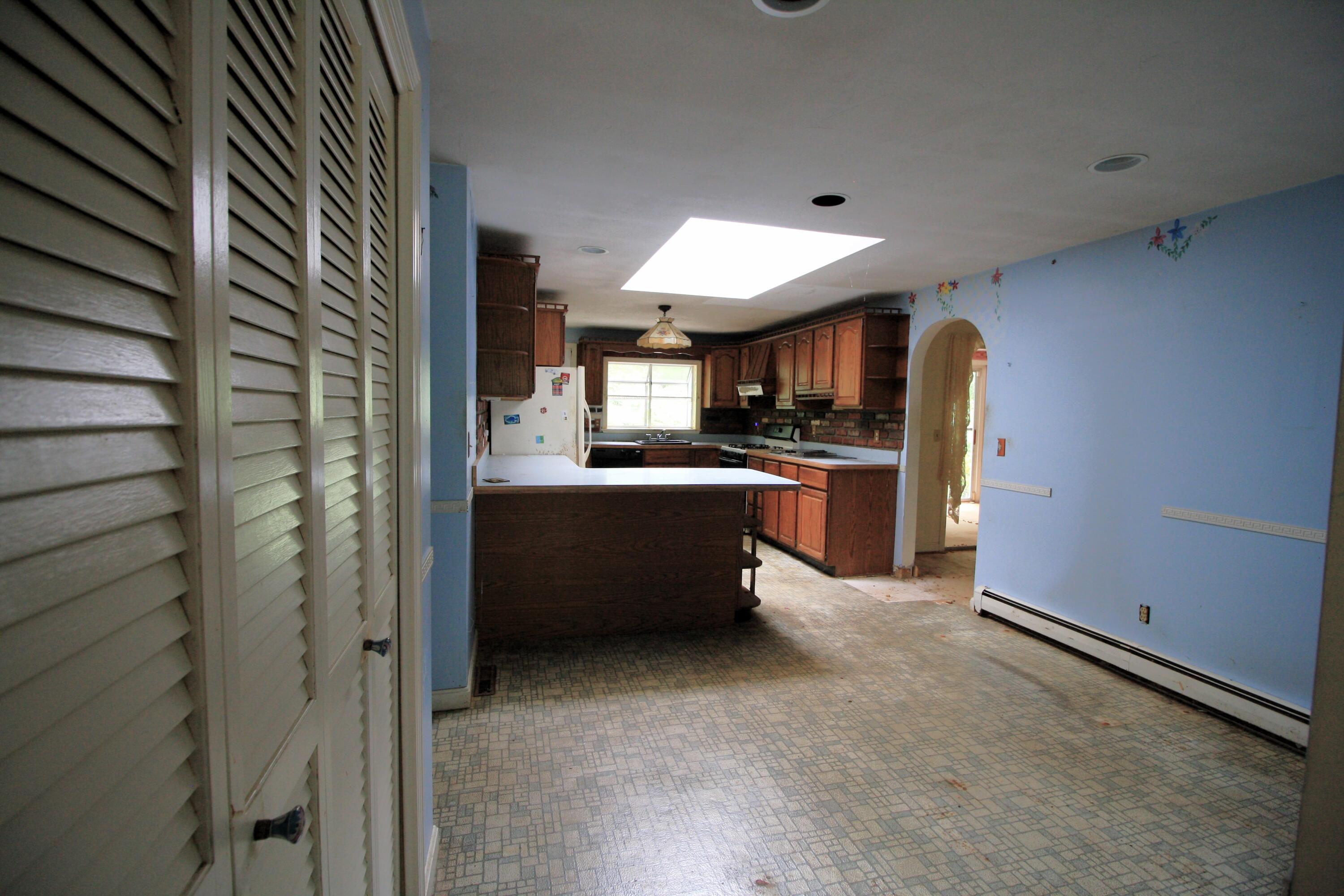 177 Thistle Drive Centerville, MA 02632 - Photo 10 of 22 a kitchen with refrigerator and cabinets