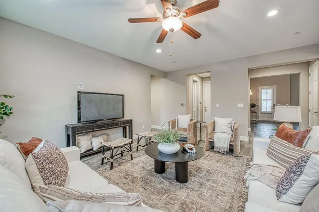 a living room with furniture a rug and a chandelier