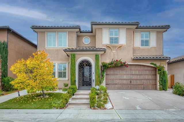 a front view of a house with a garden