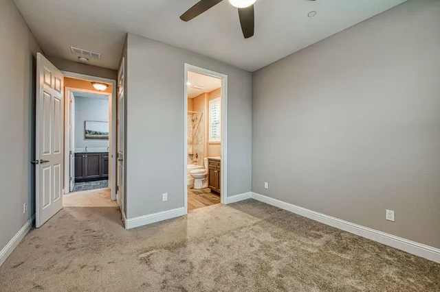 an empty room with fan and entrance