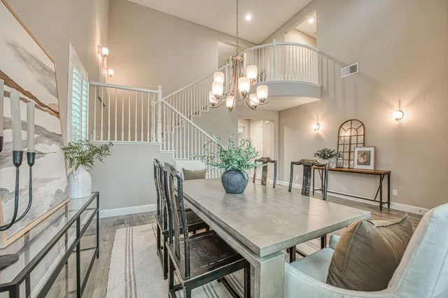 a view of a dining room with furniture and a chandelier