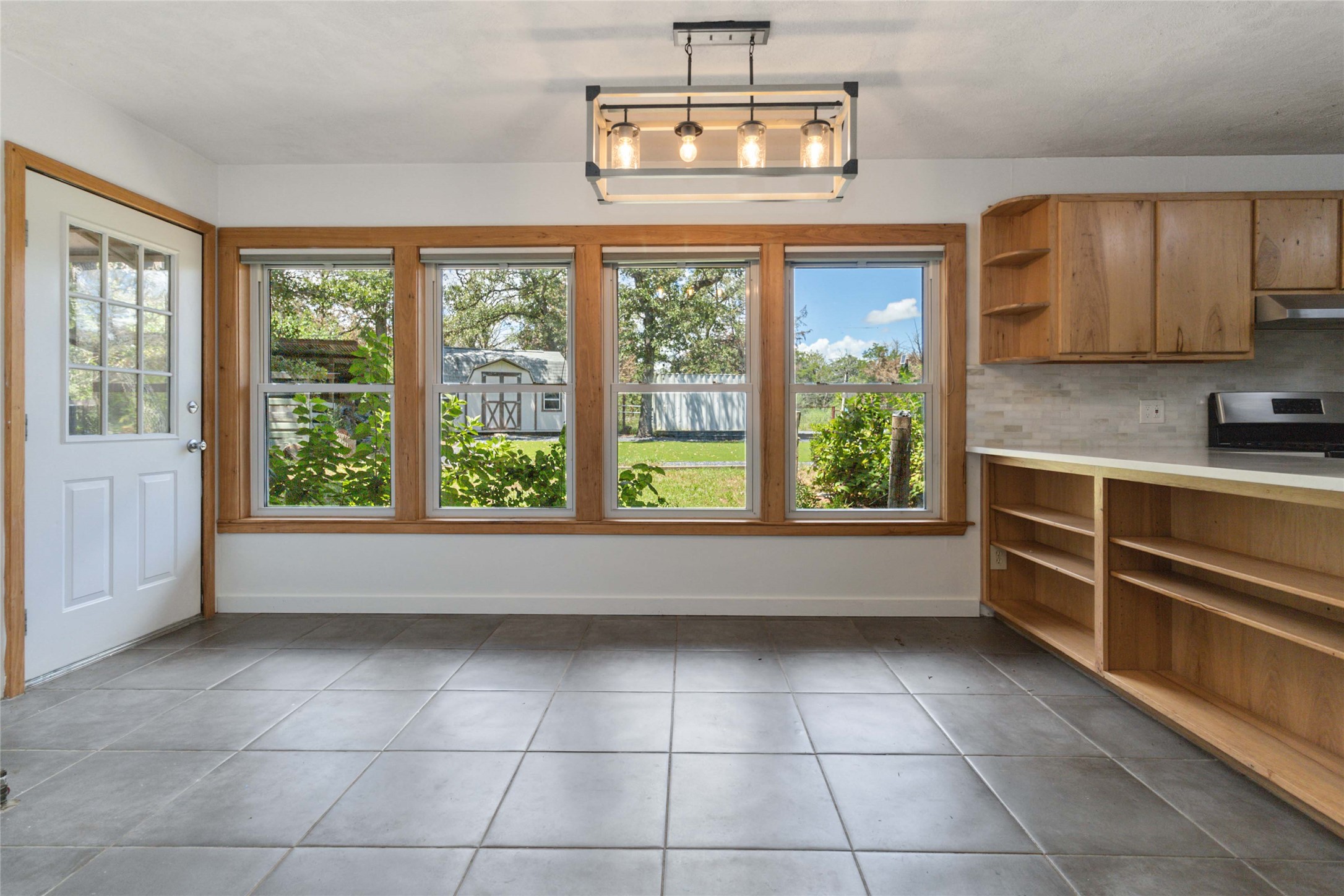 180 Ironstone Road Smithville, TX 78957 - Photo 31 of 37 Unfurnished dining area featuring baseboards and dark tile patterned floors