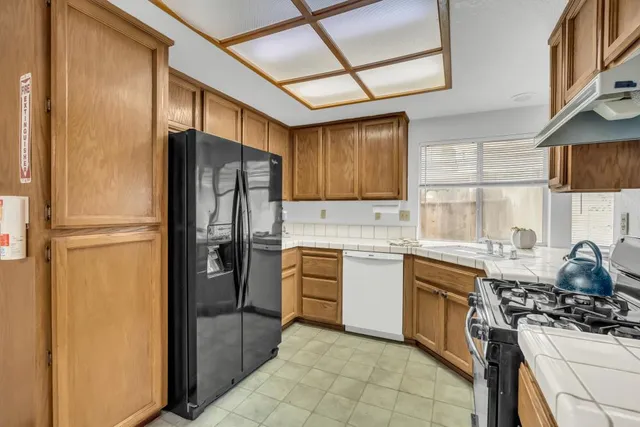 a kitchen with a sink stove and refrigerator