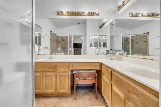 a spacious bathroom with a sink double vanity and a tub