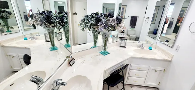 a bathroom with a sink double vanity and mirror
