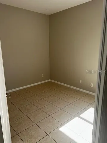 a view of an empty room and a window