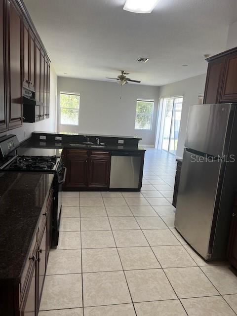20010 Daytona Way Tampa, FL 33647 - Photo 5 of 19 a kitchen with granite countertop a stove a sink a counter top space and cabinets