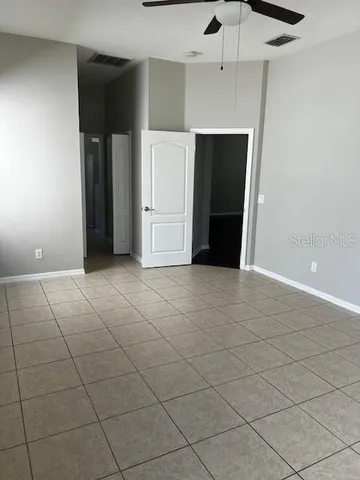 an empty room with a fireplace and cabinet