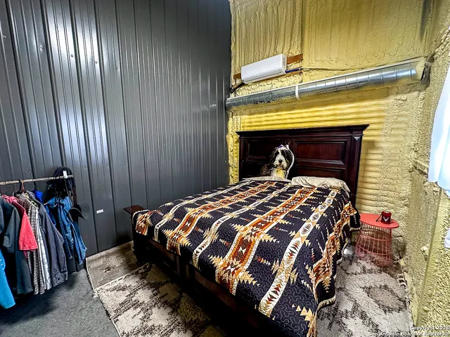 a bed sitting in a bedroom next to a window