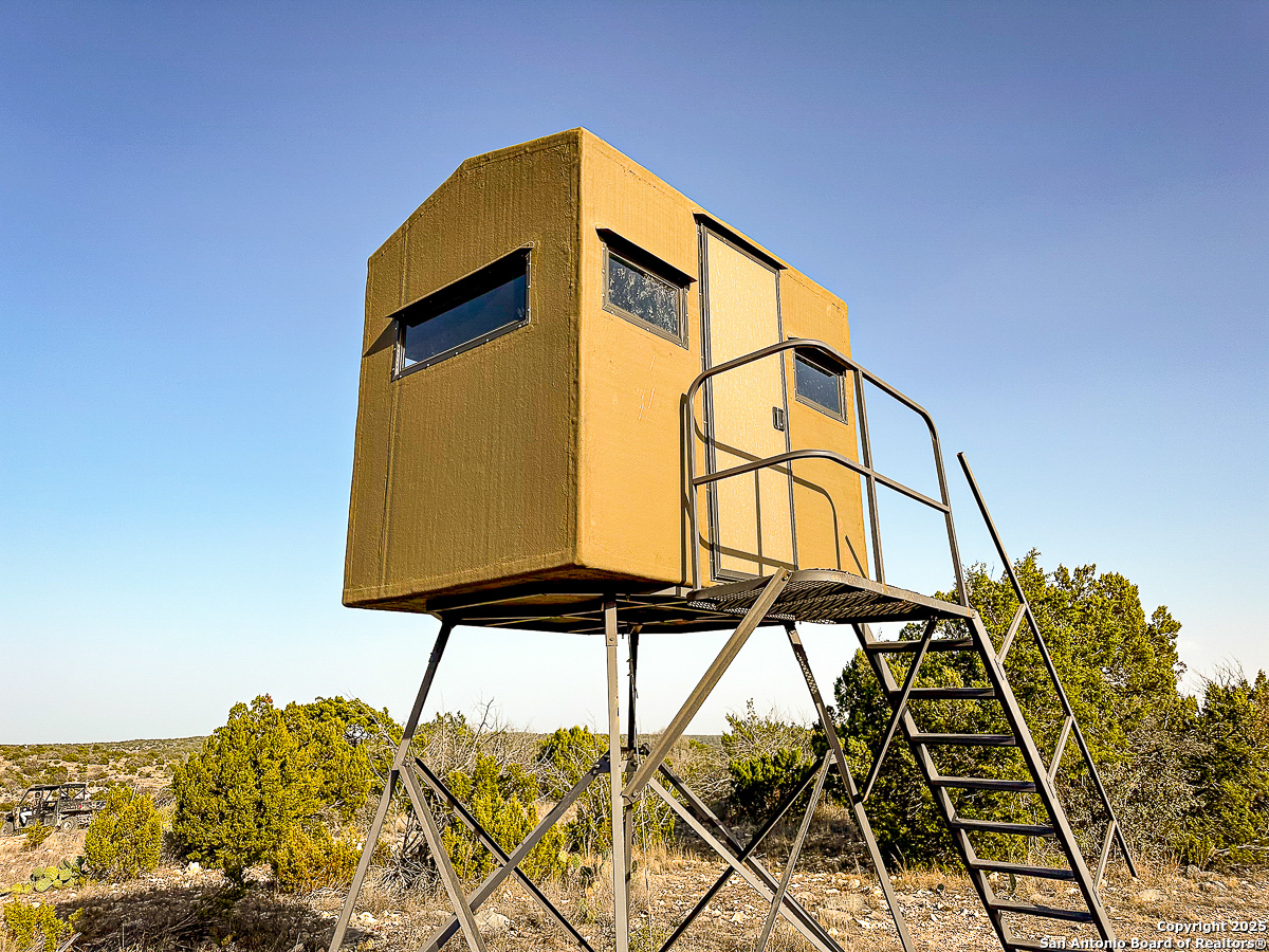 Tbd Marvin Road Comstock, TX 78837 - Photo 23 of 38 a yellow building with trees in front of it