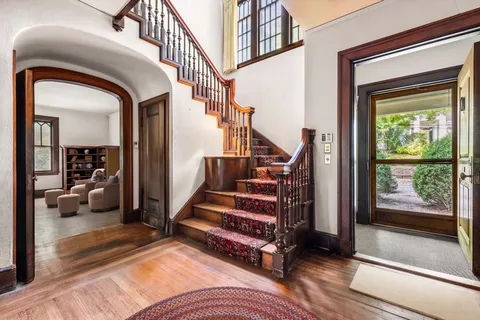 a view of a livingroom with furniture and staircase
