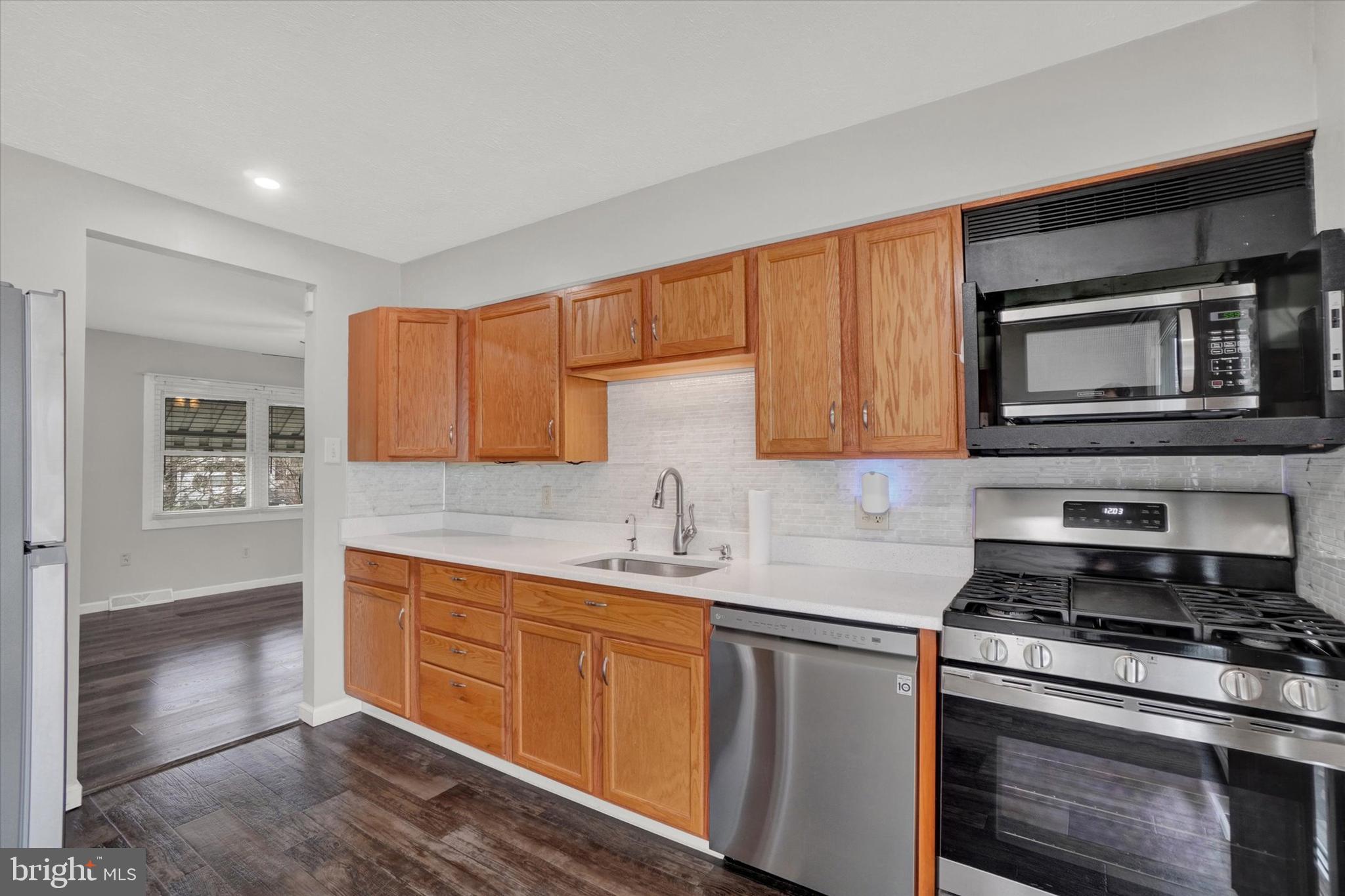 821 Gunnison Road York, PA 17404 - Photo 8 of 28 a kitchen with stainless steel appliances a stove sink microwave and cabinets