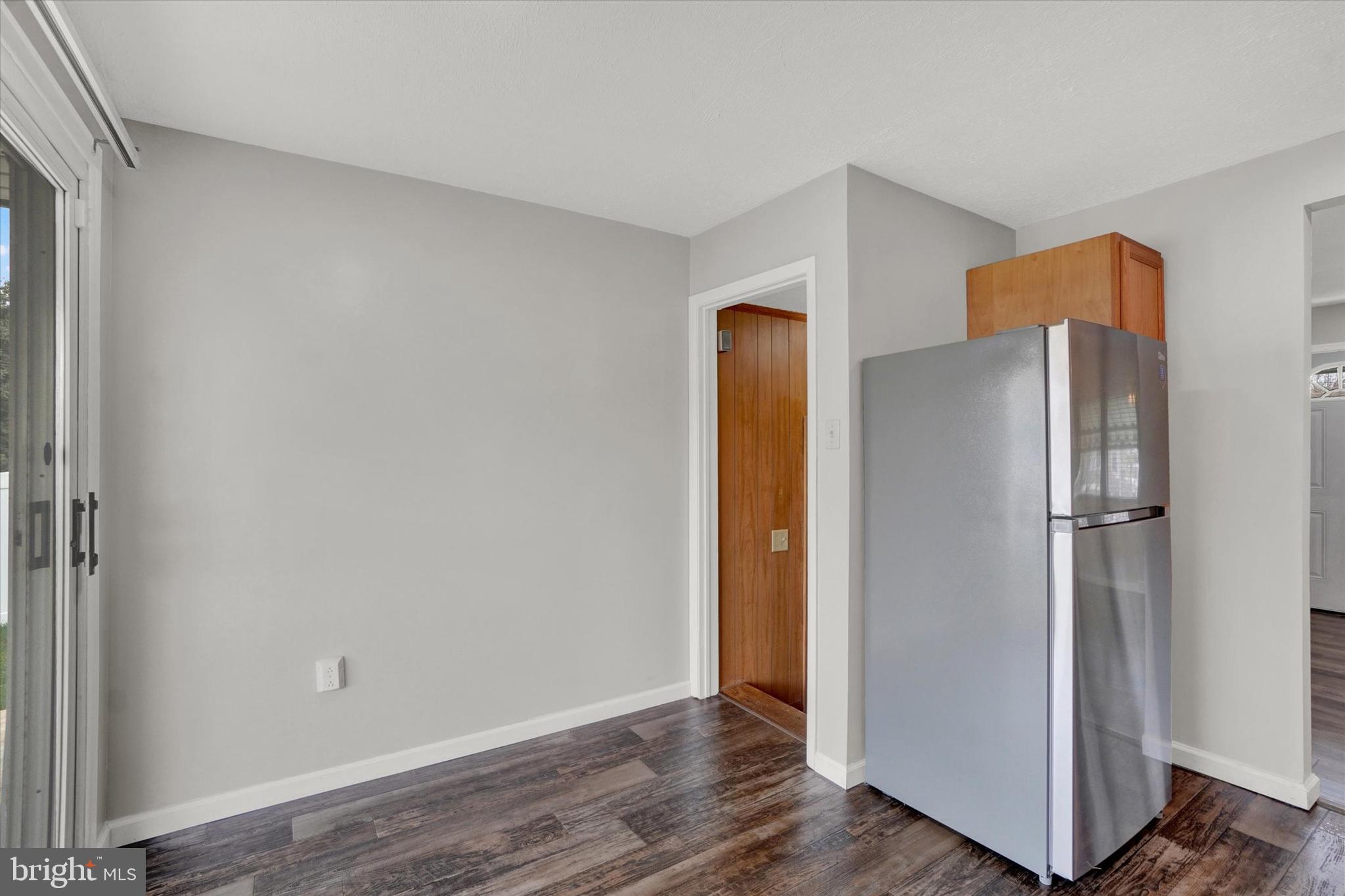 821 Gunnison Road York, PA 17404 - Photo 9 of 28 a view of an empty room with wooden floor and a cabinet