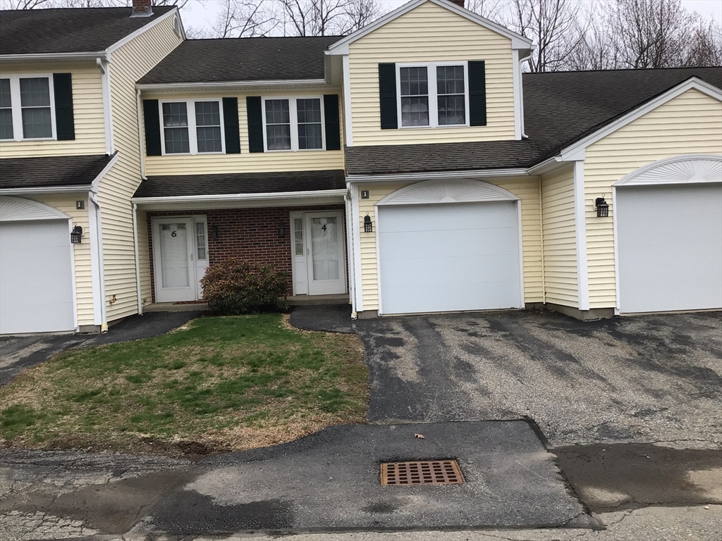 4 Village Way, Unit 4 Rutland, MA 01543 - Photo 1 of 33 a front view of a house with a yard and garage