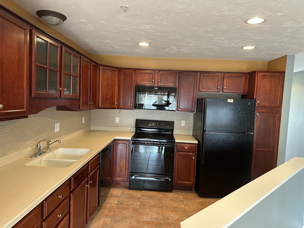 4 Village Way, Unit 4 Rutland, MA 01543 - Photo 11 of 33 a kitchen with a refrigerator sink and cabinets
