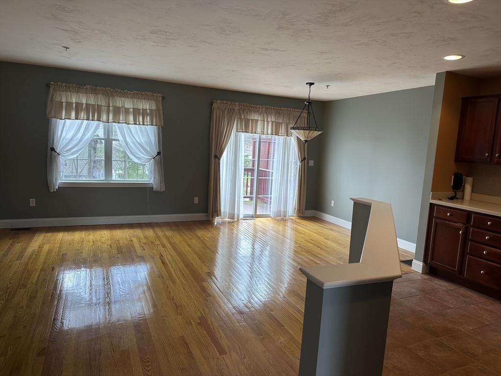 4 Village Way, Unit 4 Rutland, MA 01543 - Photo 12 of 33 a view of kitchen and dining room with furniture window wooden floor and windows