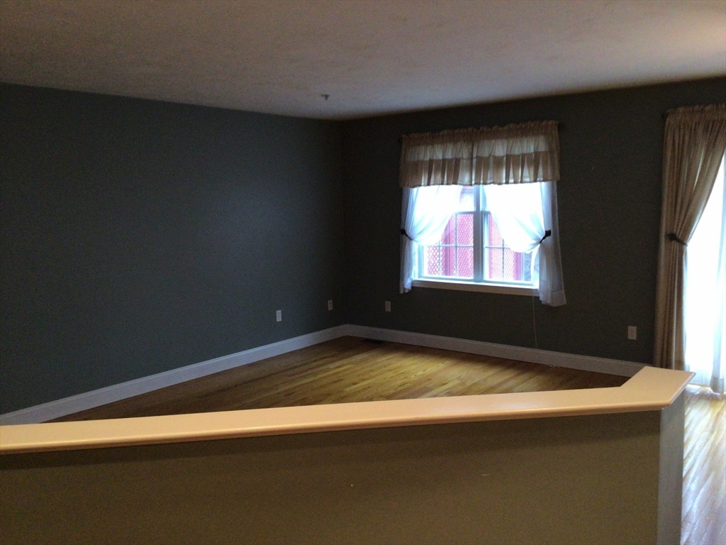 4 Village Way, Unit 4 Rutland, MA 01543 - Photo 13 of 33 a view of wooden floor and windows in a room