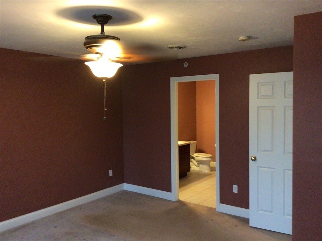 4 Village Way, Unit 4 Rutland, MA 01543 - Photo 16 of 33 wooden floor in an empty room with a bathroom