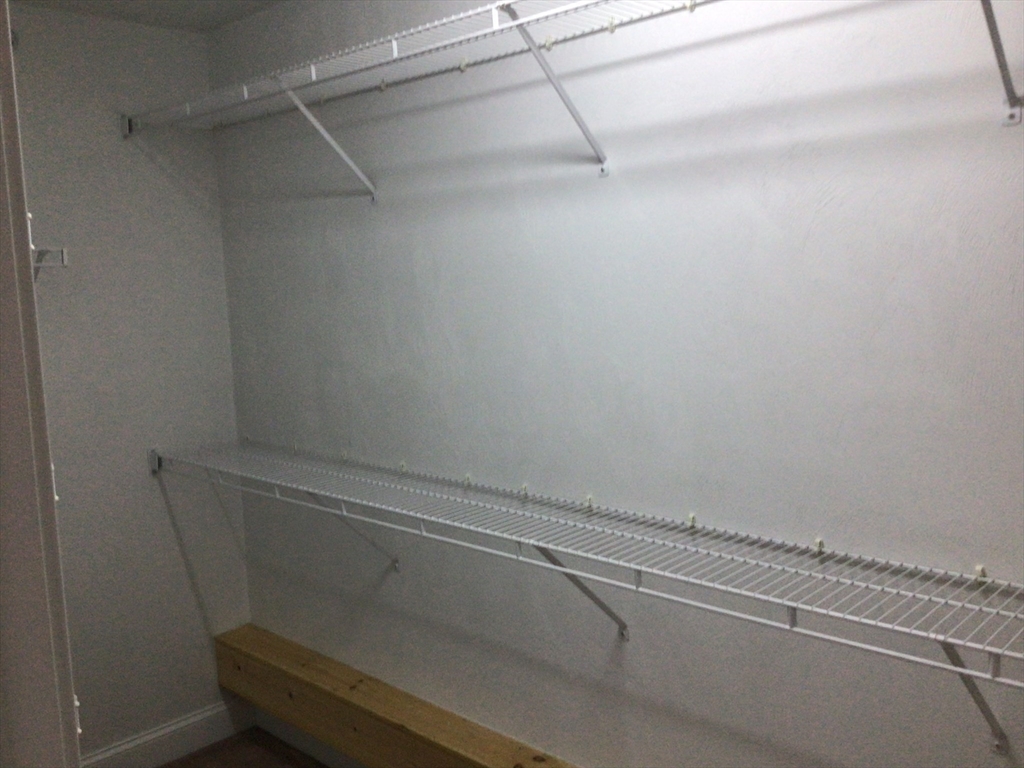 4 Village Way, Unit 4 Rutland, MA 01543 - Photo 17 of 33 a view of a room with racks on the wall