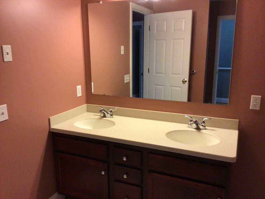 4 Village Way, Unit 4 Rutland, MA 01543 - Photo 18 of 33 a bathroom with a sink and a mirror