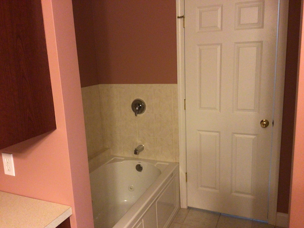 4 Village Way, Unit 4 Rutland, MA 01543 - Photo 20 of 33 a bathroom with a tub and shower
