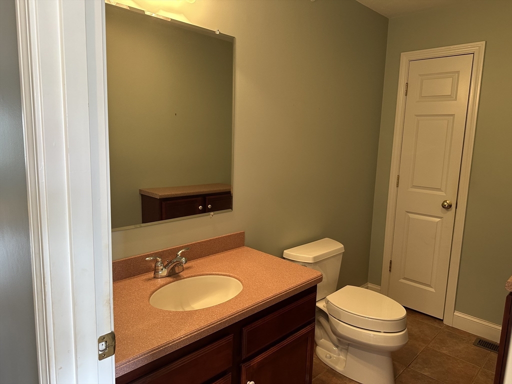 4 Village Way, Unit 4 Rutland, MA 01543 - Photo 21 of 33 a bathroom with a granite countertop sink and a mirror