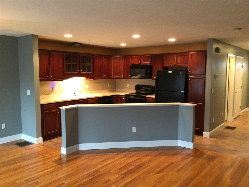 4 Village Way, Unit 4 Rutland, MA 01543 - Photo 5 of 33 a view of kitchen with wooden floor