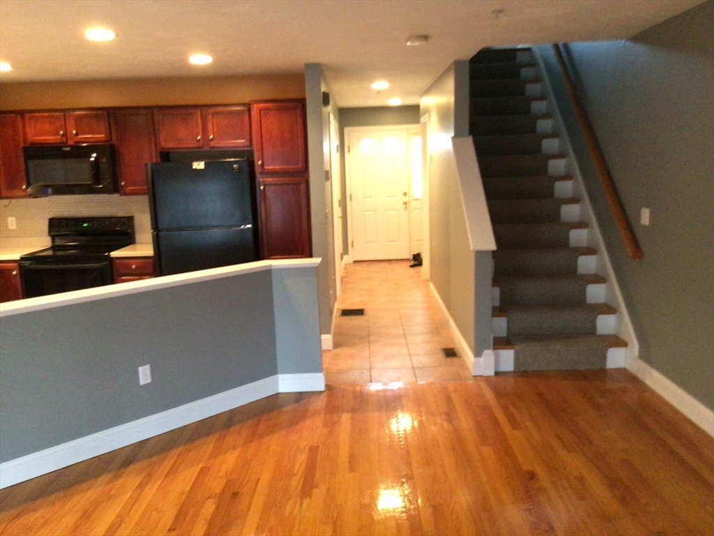4 Village Way, Unit 4 Rutland, MA 01543 - Photo 7 of 33 a view of a living room with wooden floor