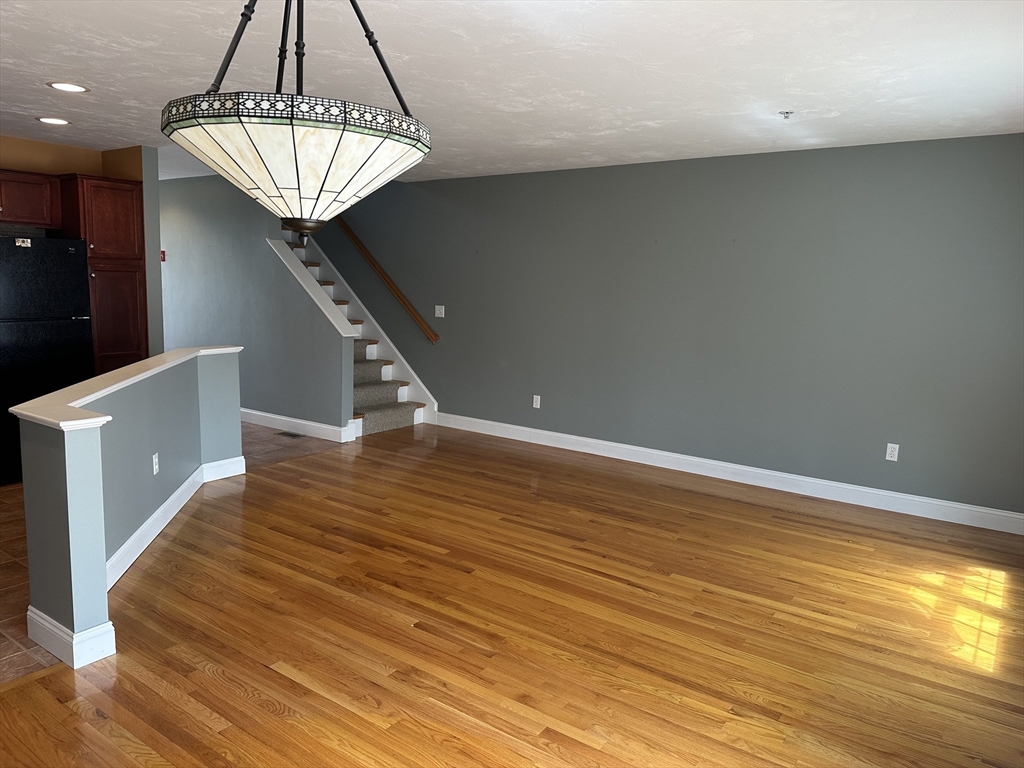 4 Village Way, Unit 4 Rutland, MA 01543 - Photo 8 of 33 a room with wooden floor and staircase