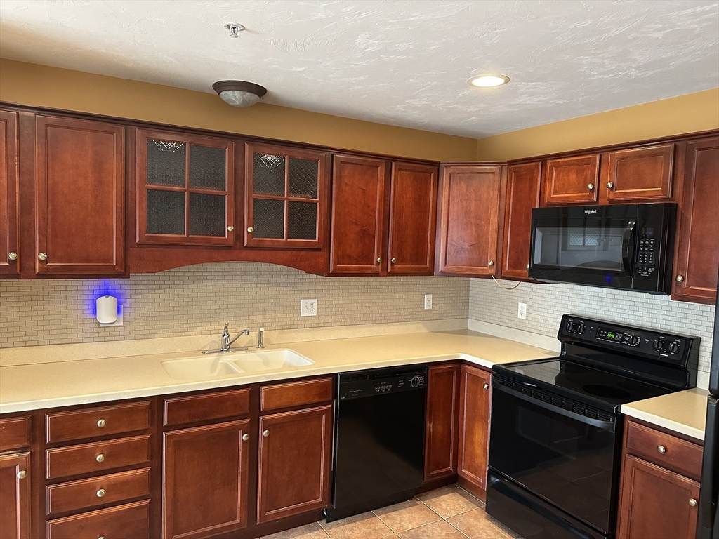 4 Village Way, Unit 4 Rutland, MA 01543 - Photo 9 of 33 a kitchen with a sink and a stove top oven