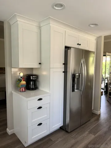 a kitchen with stainless steel appliances a refrigerator a sink and cabinets