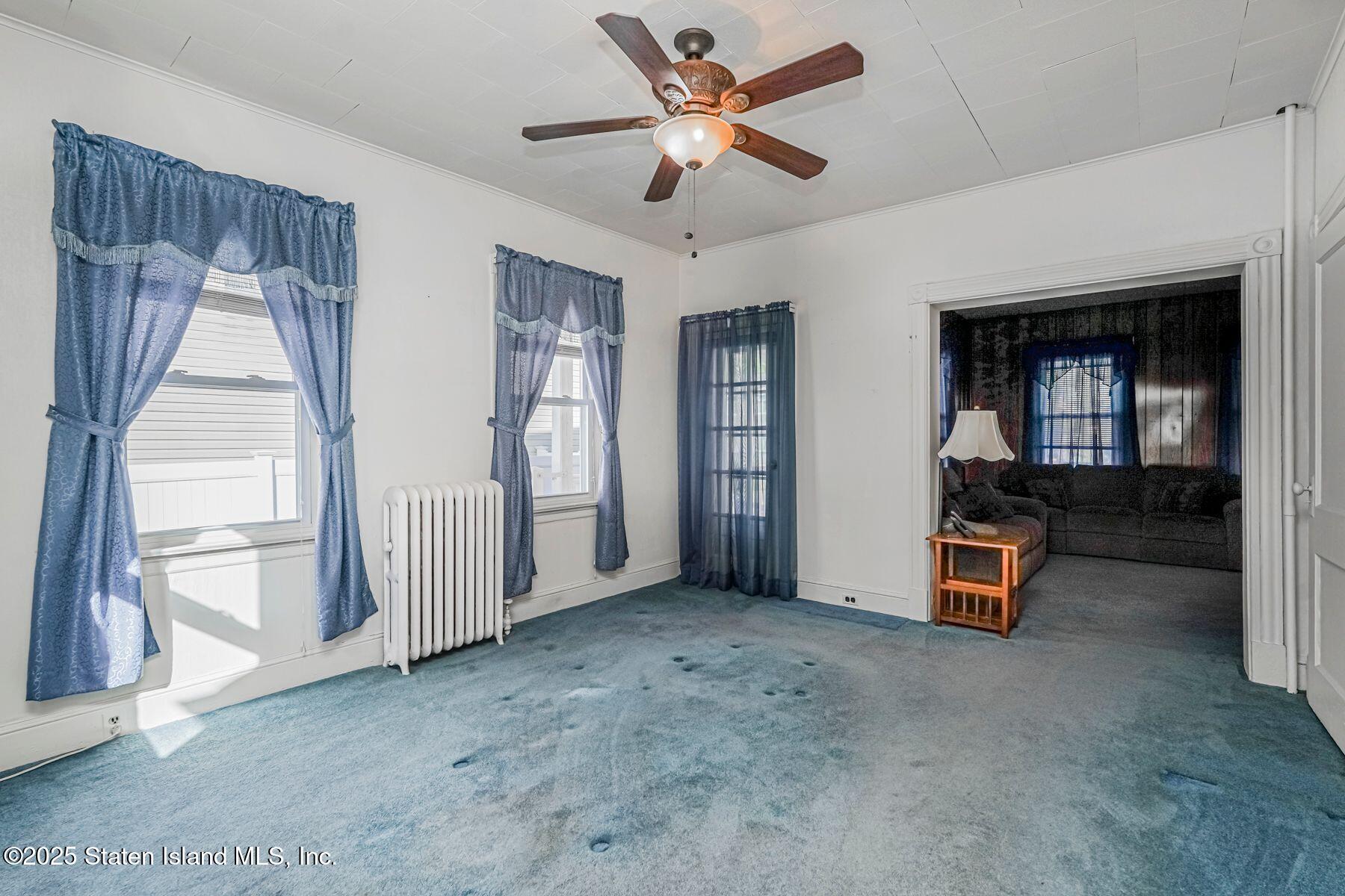 5300 Amboy Road Staten Island, NY 10312 - Photo 12 of 32 a view of a livingroom with a ceiling fan and window
