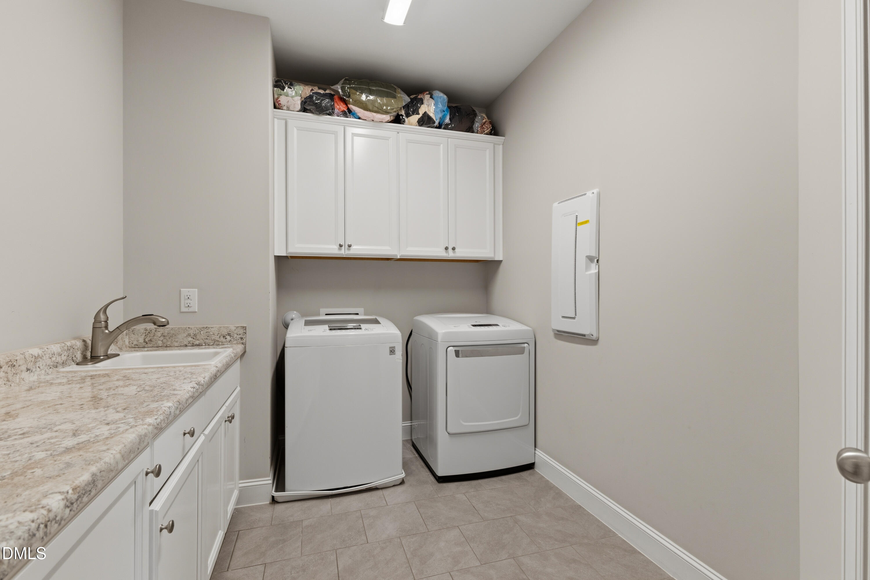 7421 Stonehenge Farm Lane Raleigh, NC 27613 - Photo 27 of 48 a utility room with cabinets washer and dryer