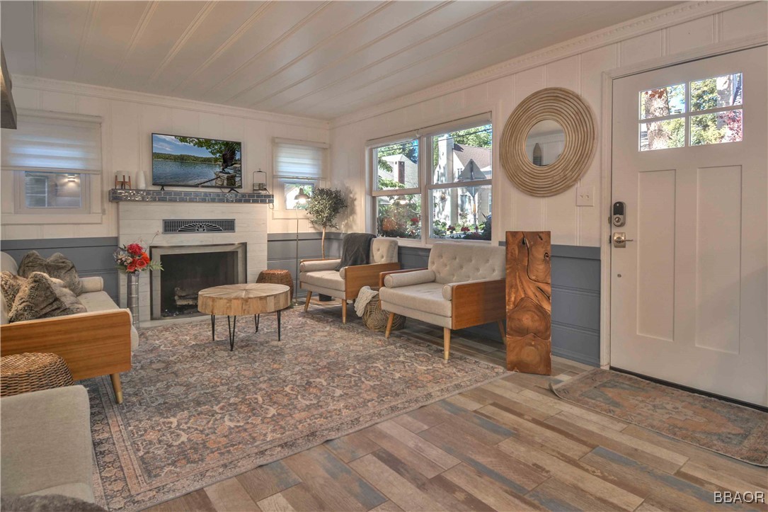 381 Maple Drive Lake Arrowhead, CA 92352 - Photo 2 of 26 a living room with furniture a fireplace and a flat screen tv