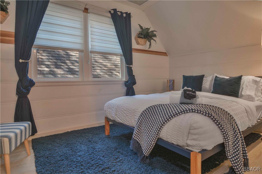 381 Maple Drive Lake Arrowhead, CA 92352 - Photo 22 of 26 a bedroom with a bed and a window