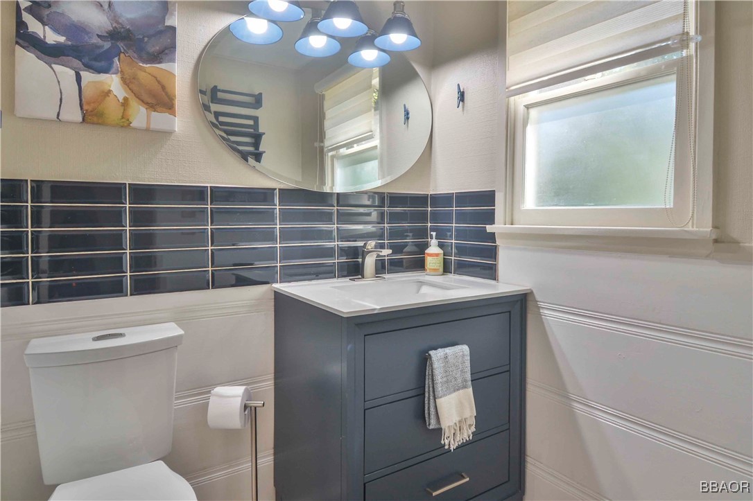 381 Maple Drive Lake Arrowhead, CA 92352 - Photo 23 of 26 a bathroom with a sink a toilet and a mirror