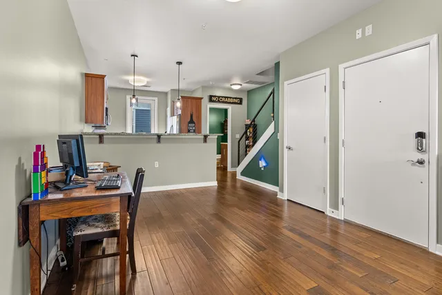 a view of a workspace with furniture and wooden floor
