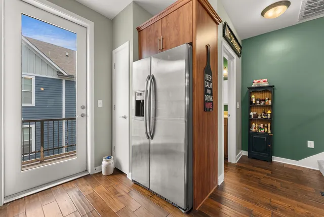 a view of a refrigerator in kitchen and wooden floor
