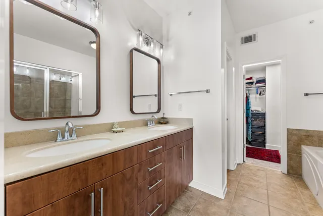 a bathroom with a double vanity sink mirror and