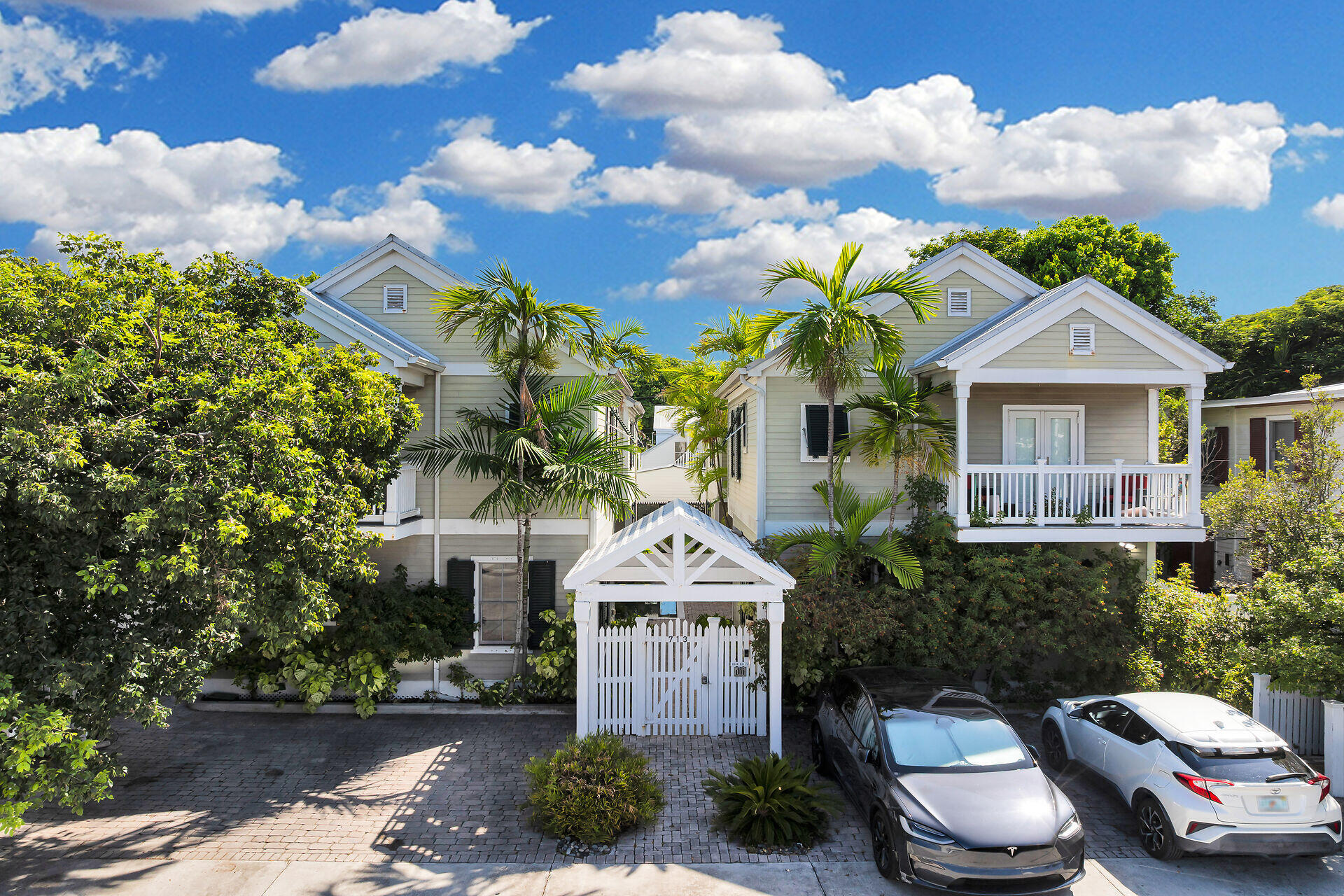 a front view of a house with a yard and balcony