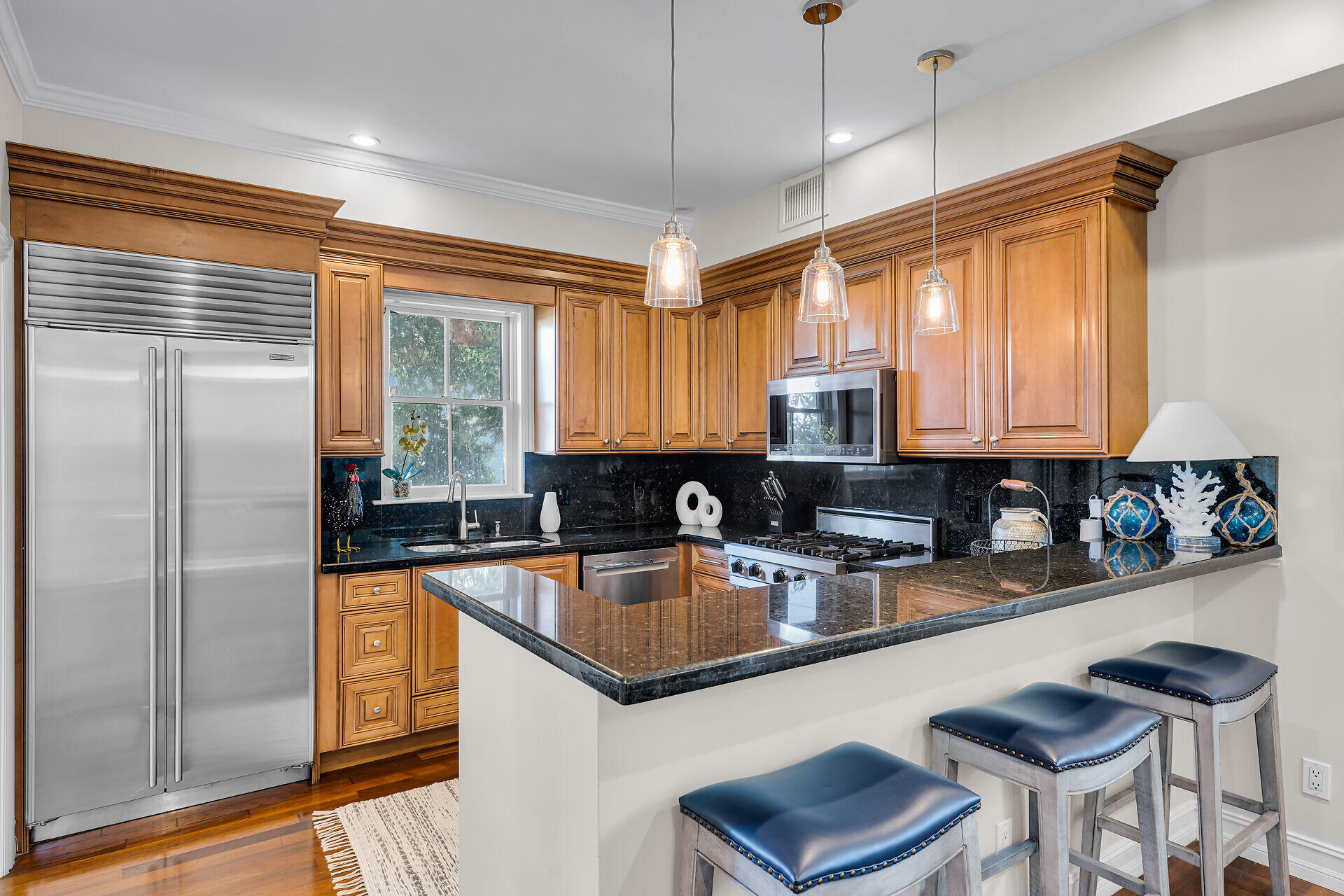 713 Emma Street, Unit 1 Key West, FL 33040 - Photo 13 of 42 a kitchen with stainless steel appliances granite countertop a sink refrigerator and microwave