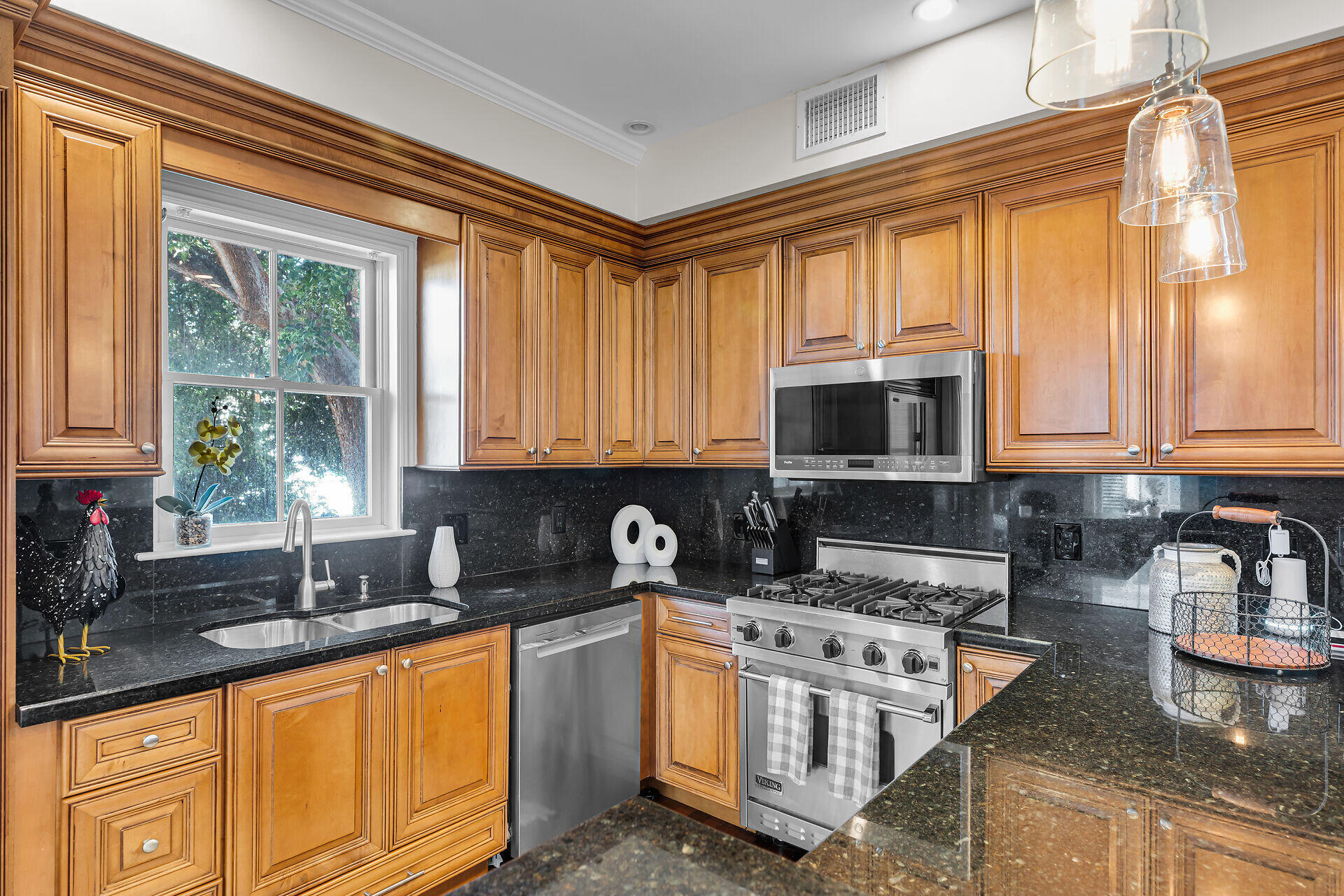 713 Emma Street, Unit 1 Key West, FL 33040 - Photo 17 of 42 a kitchen with stainless steel appliances granite countertop a sink stove and cabinets
