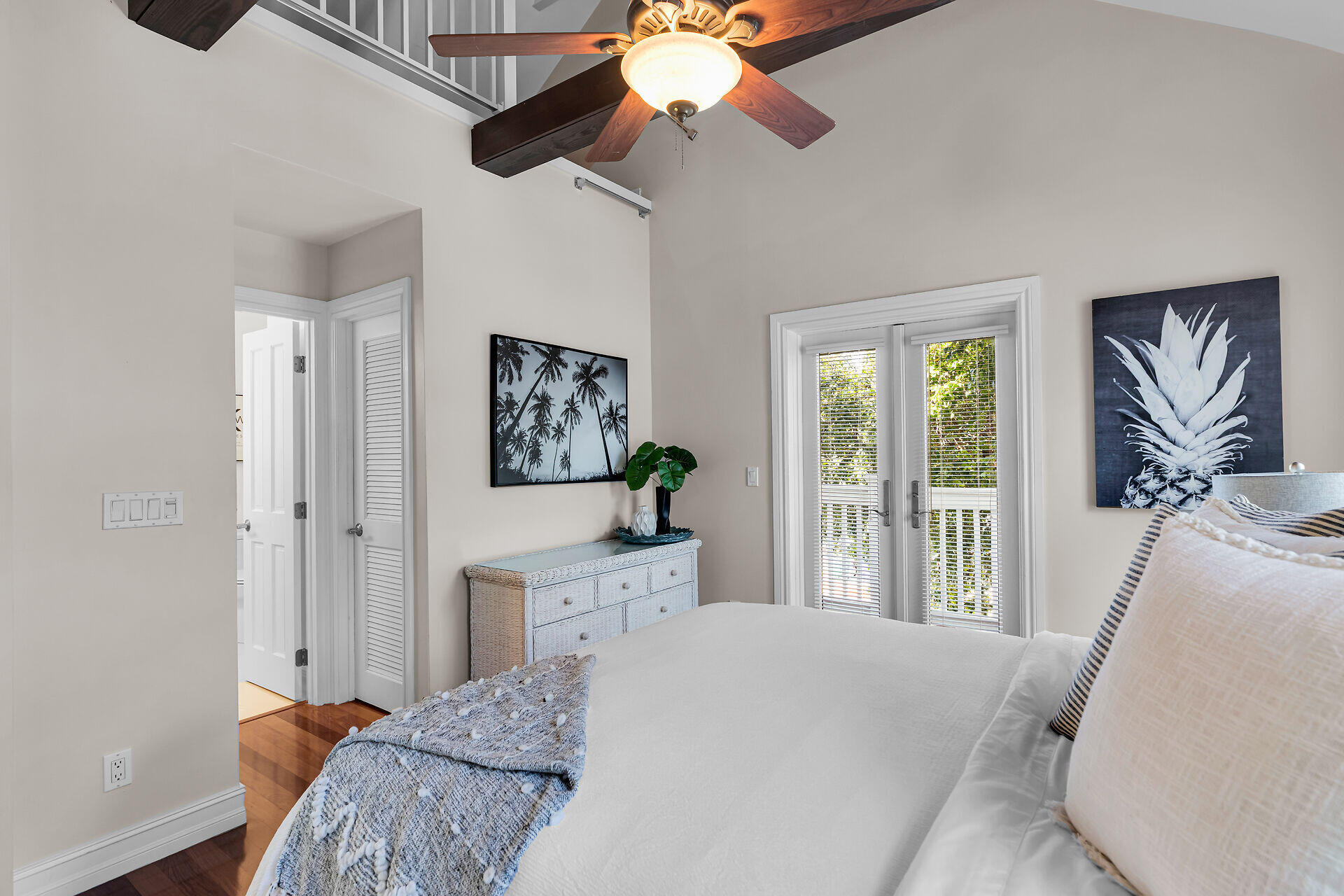 713 Emma Street, Unit 1 Key West, FL 33040 - Photo 28 of 42 a bedroom with a bed and a chandelier