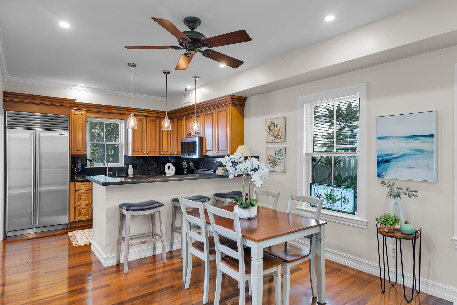 713 Emma Street, Unit 1 Key West, FL 33040 - Photo 3 of 42 a kitchen with a counter space dining table and stainless steel appliances