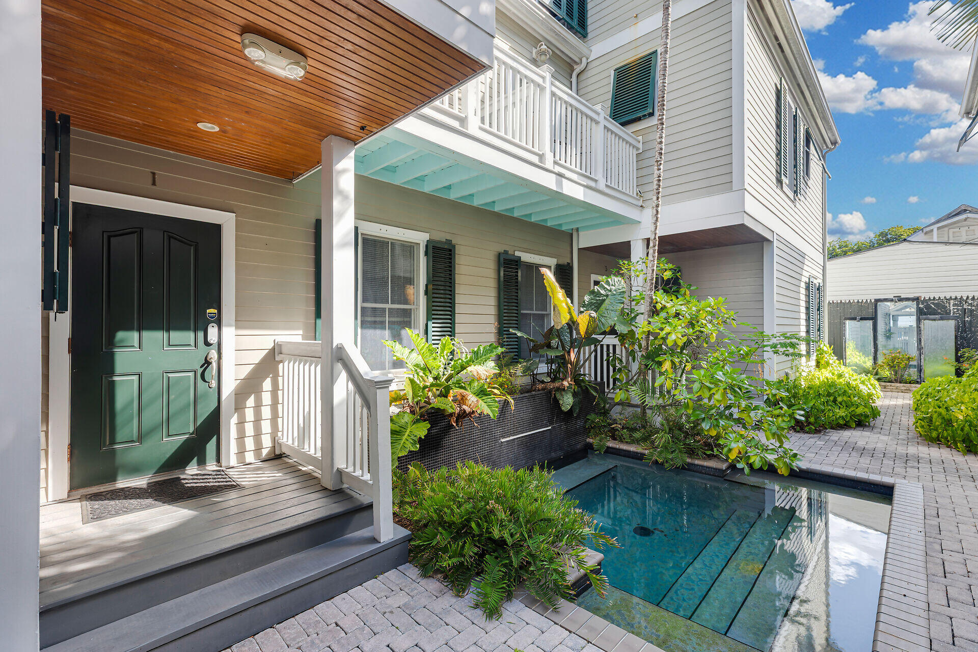 713 Emma Street, Unit 1 Key West, FL 33040 - Photo 8 of 42 a front view of a house with a garden