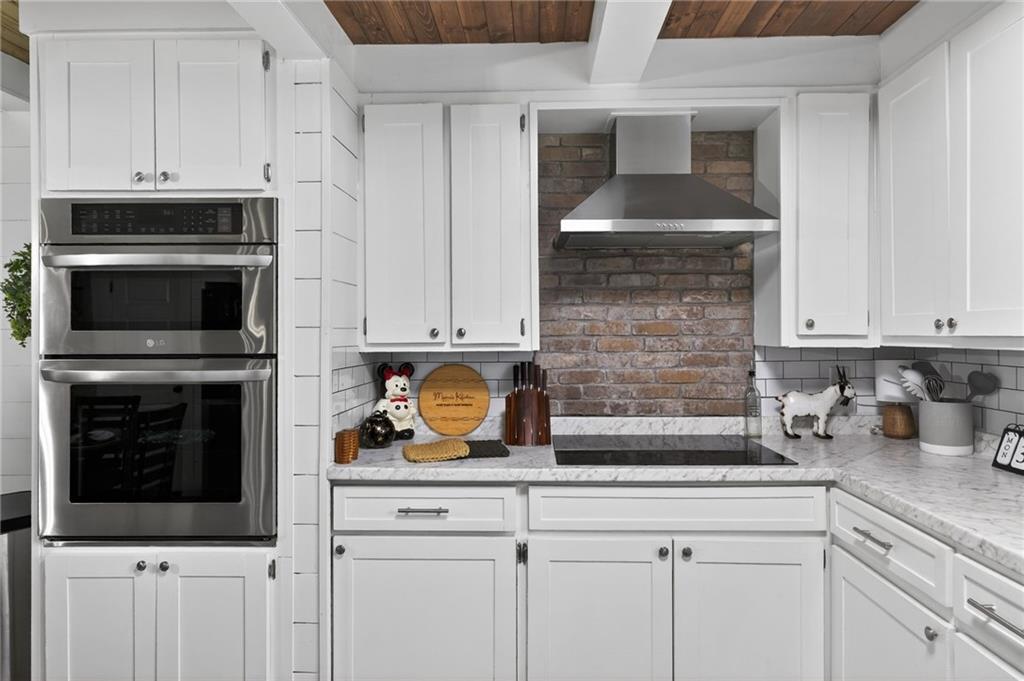 3590 Roosterville Road Roopville, GA 30170 - Photo 28 of 66 a kitchen with appliances a sink and cabinets