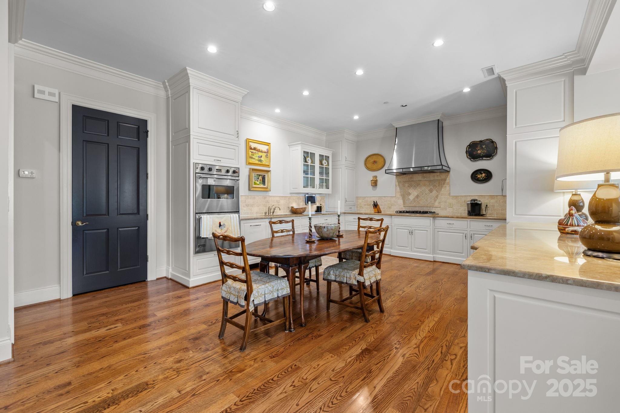 168 Cherokee Road Charlotte, NC 28207 - Photo 14 of 44 a view of a dining room with furniture and wooden floor