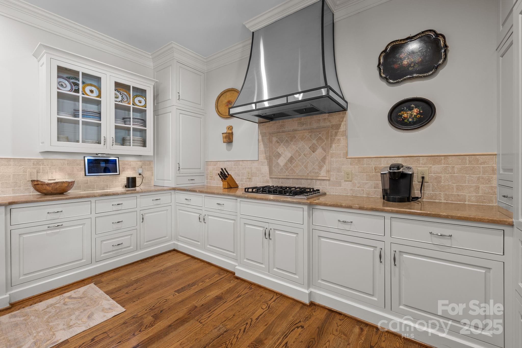 168 Cherokee Road Charlotte, NC 28207 - Photo 18 of 44 a kitchen with cabinets stainless steel appliances and wooden floor